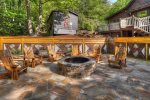Huge outdoor patio area with fire pit and Adirondack chairs